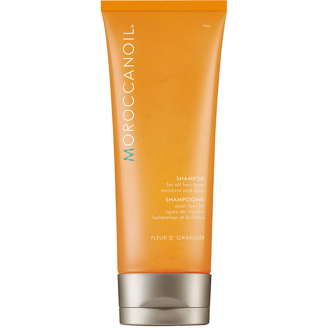 Moroccanoil Fleur D'Oranger Moisture And Shine Shampoo bottle with a floral design, showcasing its luxurious and hydrating properties.