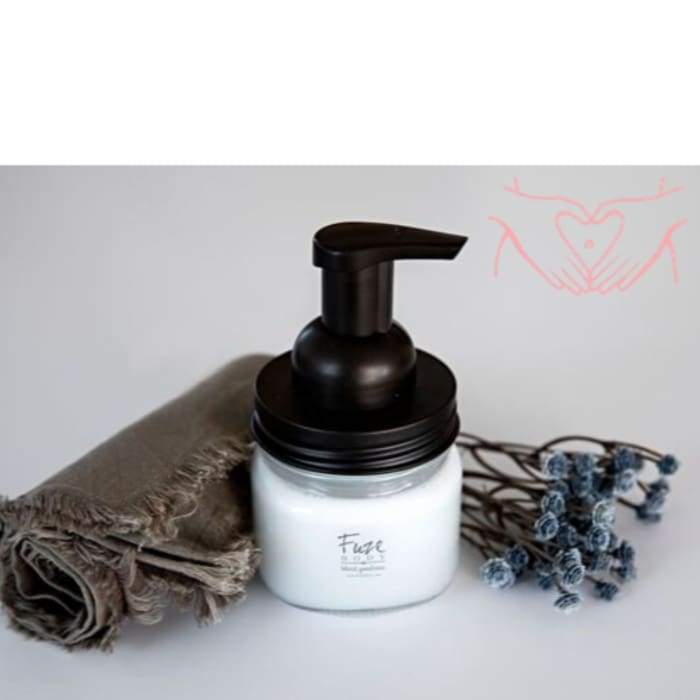 Foaming Essential Oil Hand Soap in a reusable glass jar with bronze accents, featuring a packet of concentrated soap base.