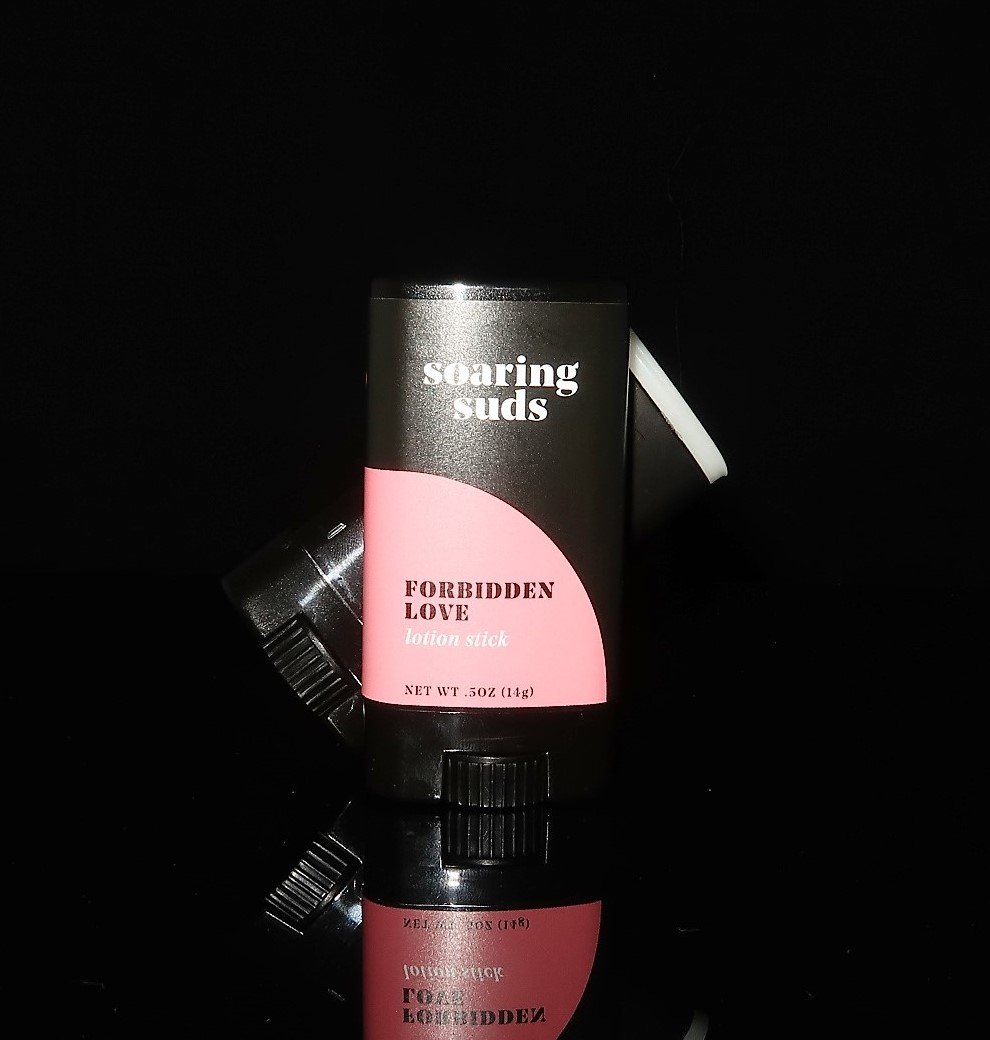 Forbidden Love Lotion Stick with citrus and rose scent, showcasing its solid form and natural ingredients.