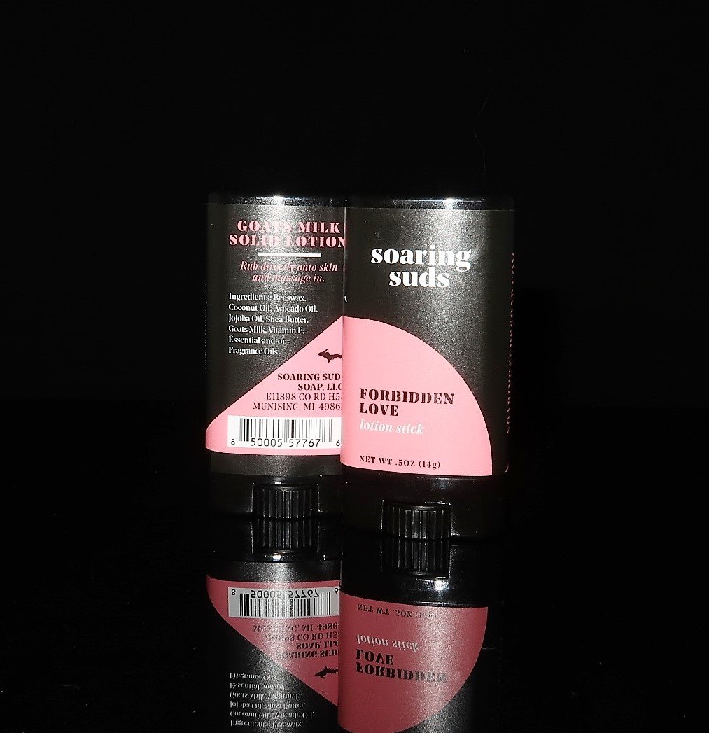 Forbidden Love Lotion Stick with citrus and rose scent, showcasing its solid form and natural ingredients.