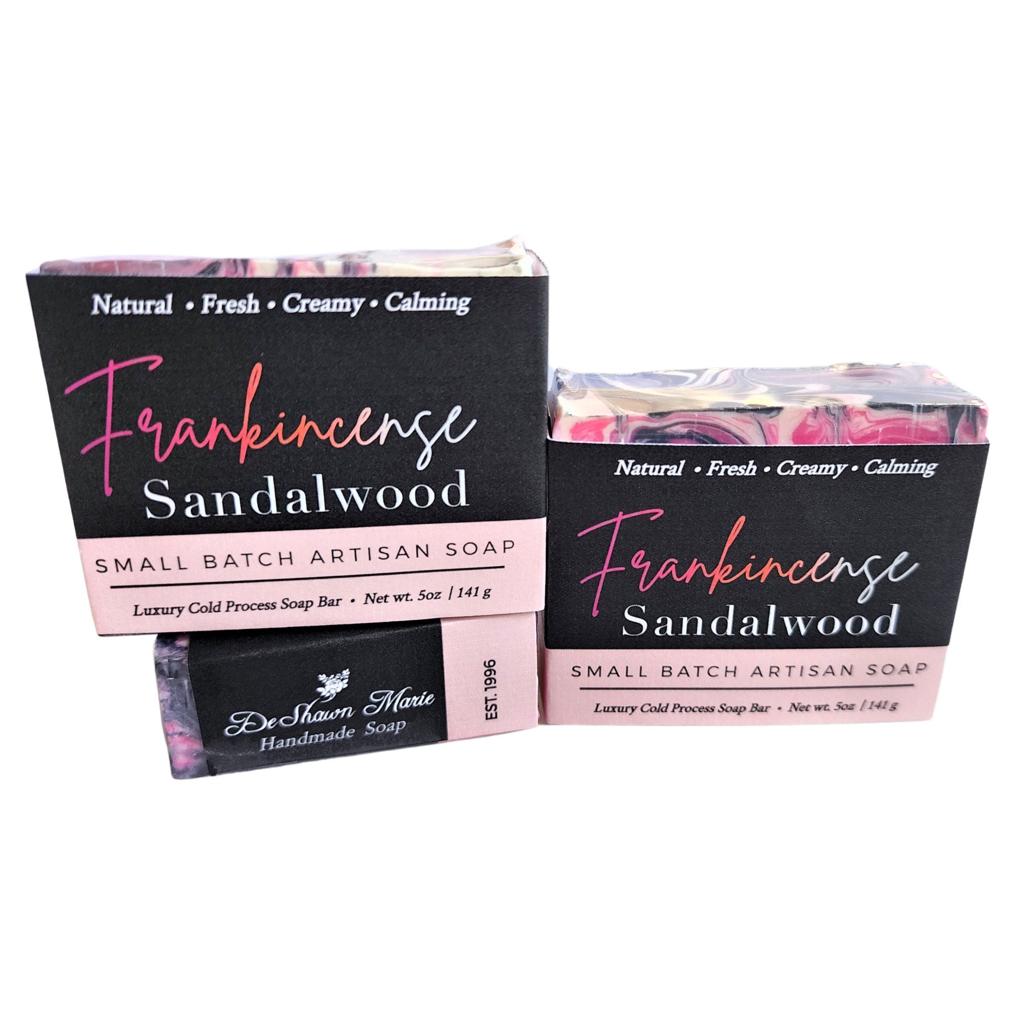 A beautifully crafted Frankincense Sandalwood Soap bar featuring pink, black, and white swirls with activated charcoal.