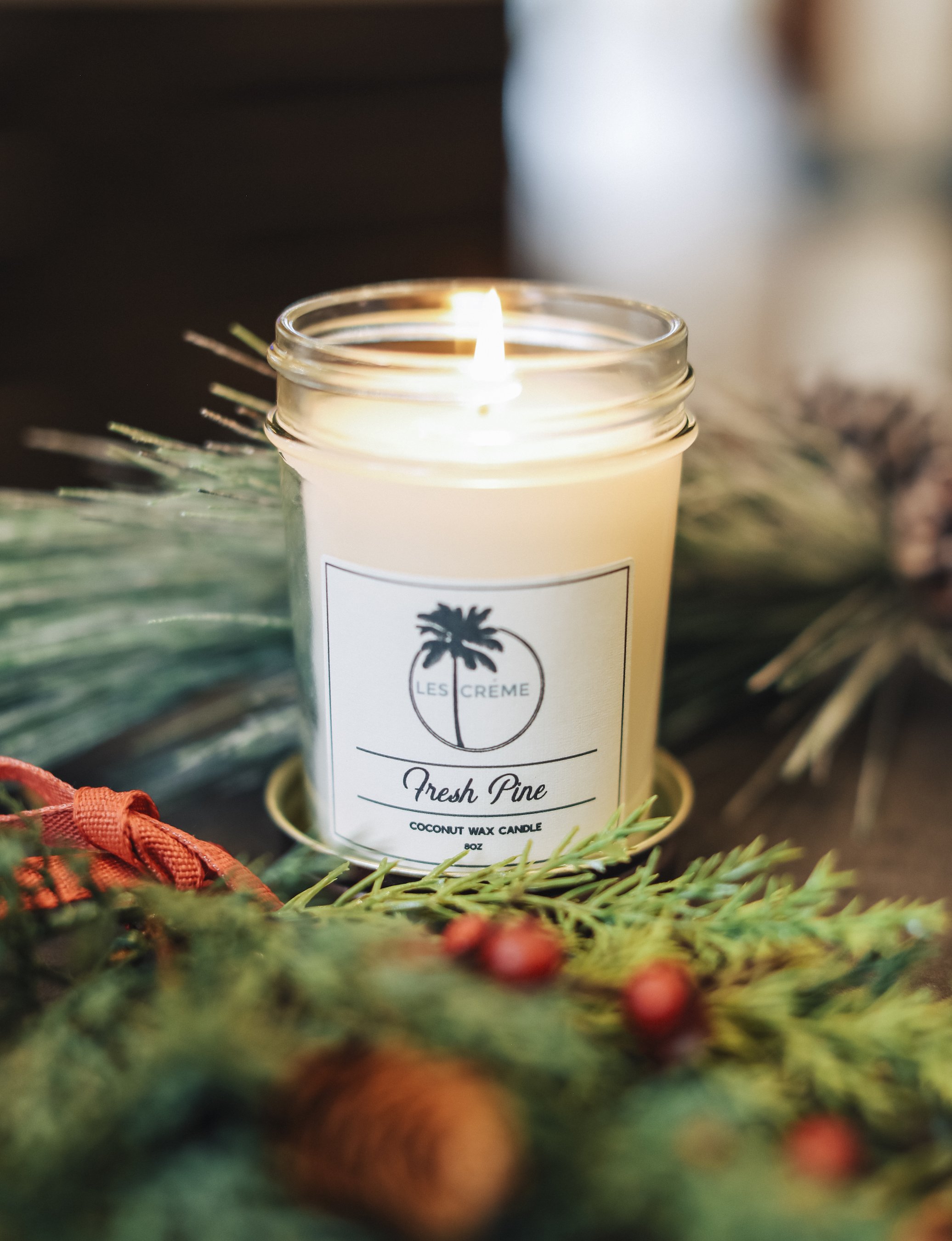 Fresh Pine Scent Coconut Wax Candle in a glass jar, showcasing its natural ingredients and inviting aroma.