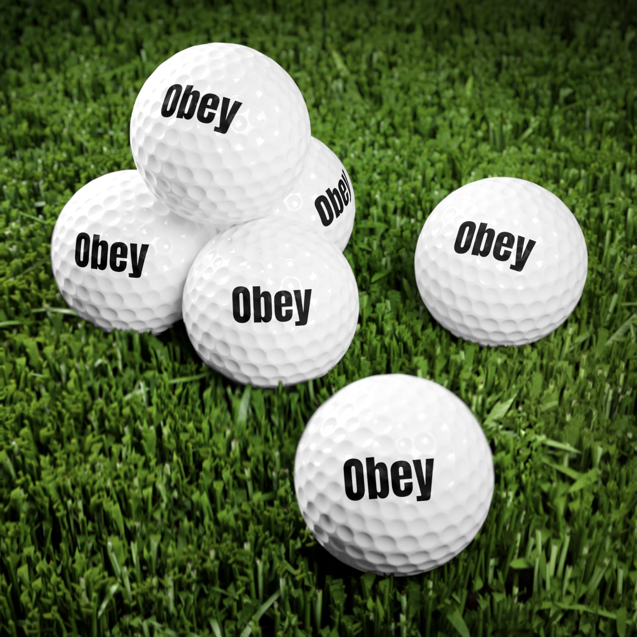 A pack of 6 personalized Obey golf balls made from durable surlyn, showcasing their standard size and quality design.
