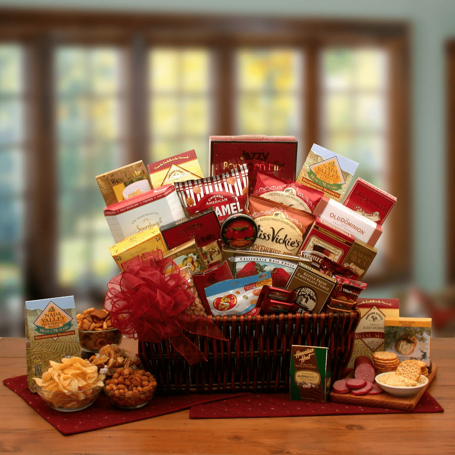 Gourmet Ambassador Gourmet Gift Basket filled with assorted gourmet treats, beautifully arranged in a dark stain willow tray and topped with a handmade bow.