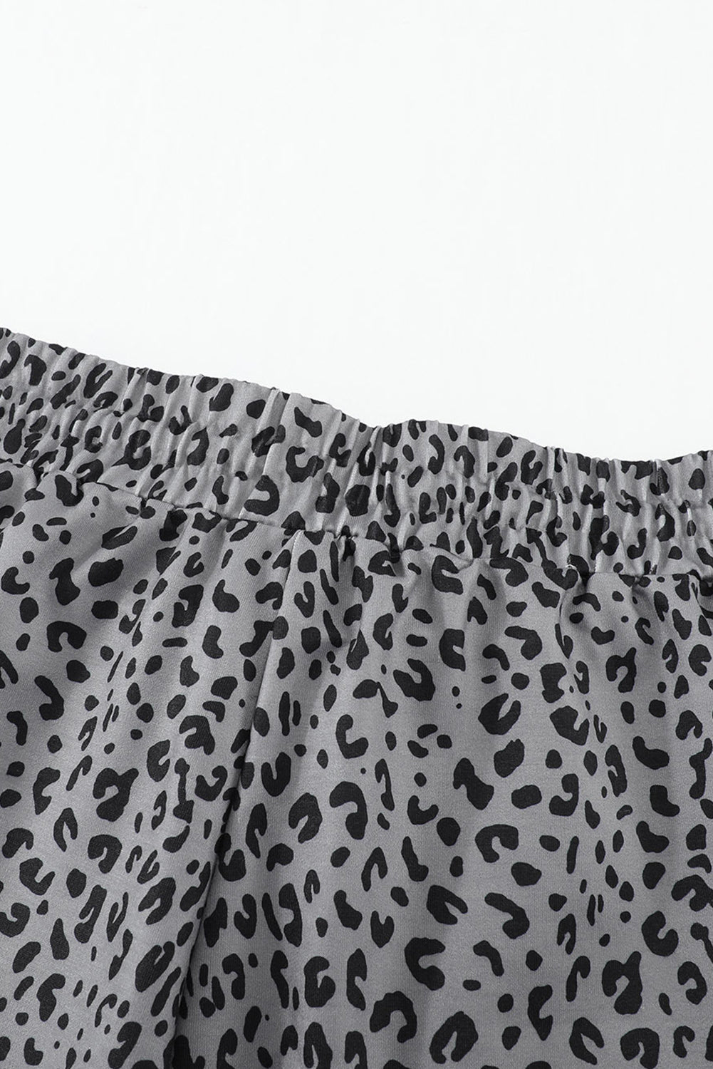 Gray joggers featuring a stylish leopard print design with a self-tie adjustable smocked waist for a comfortable fit.