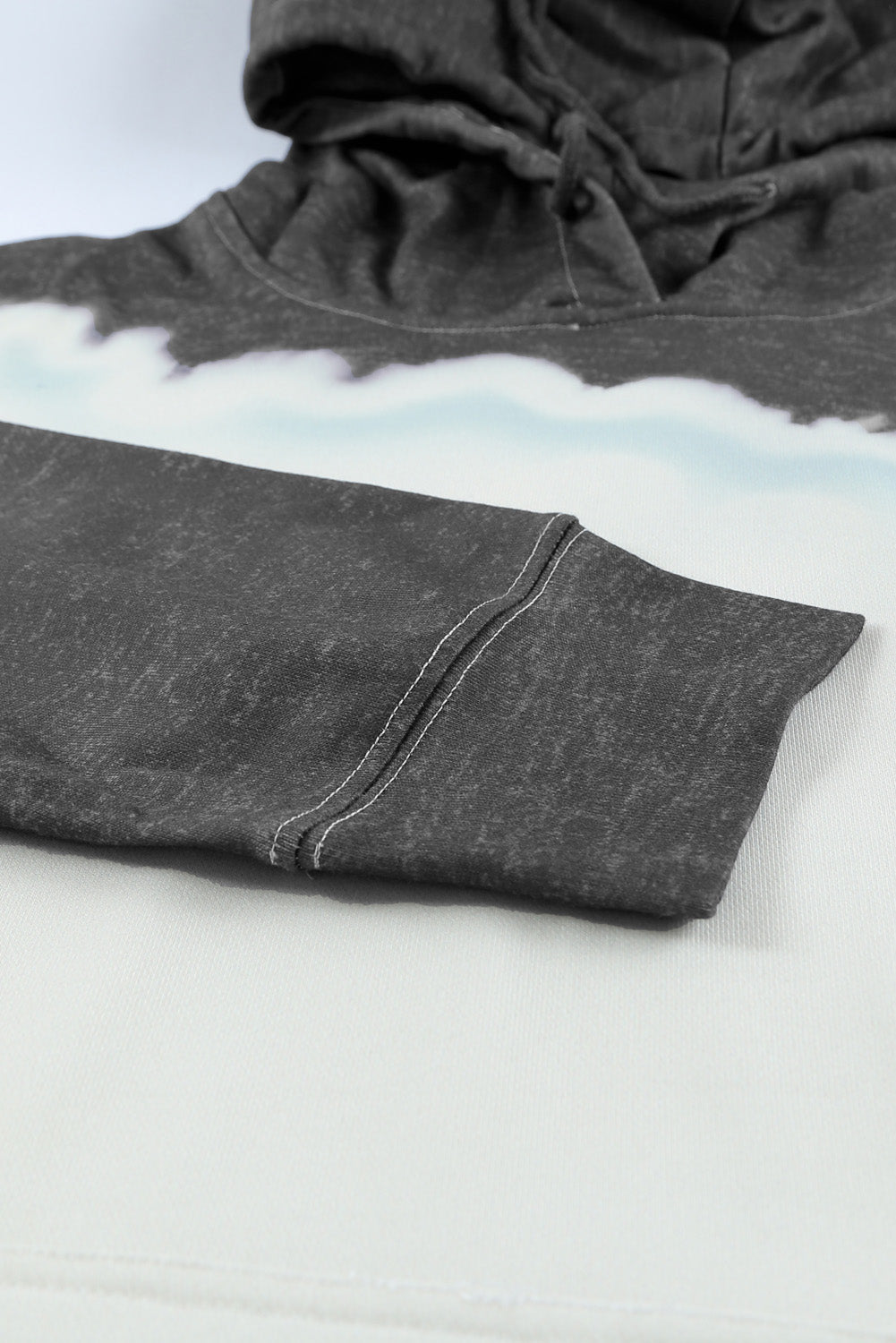 Gray hooded sweatshirt featuring a stylish tie-dye print and a functional front pocket, perfect for casual wear.