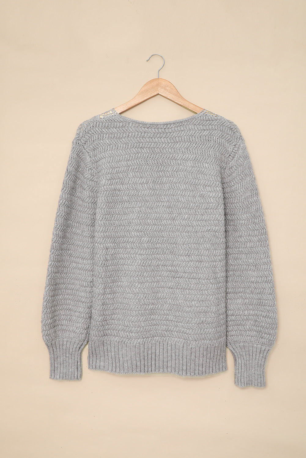 Gray loose sweater featuring a lace scalloped V-neck and side split design, perfect for a chic and comfortable look.