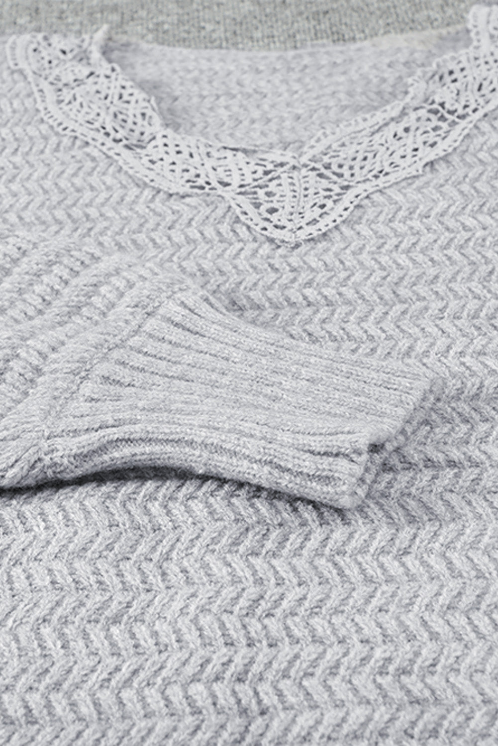 Gray loose sweater featuring a lace scalloped V-neck and side split design, perfect for a chic and comfortable look.