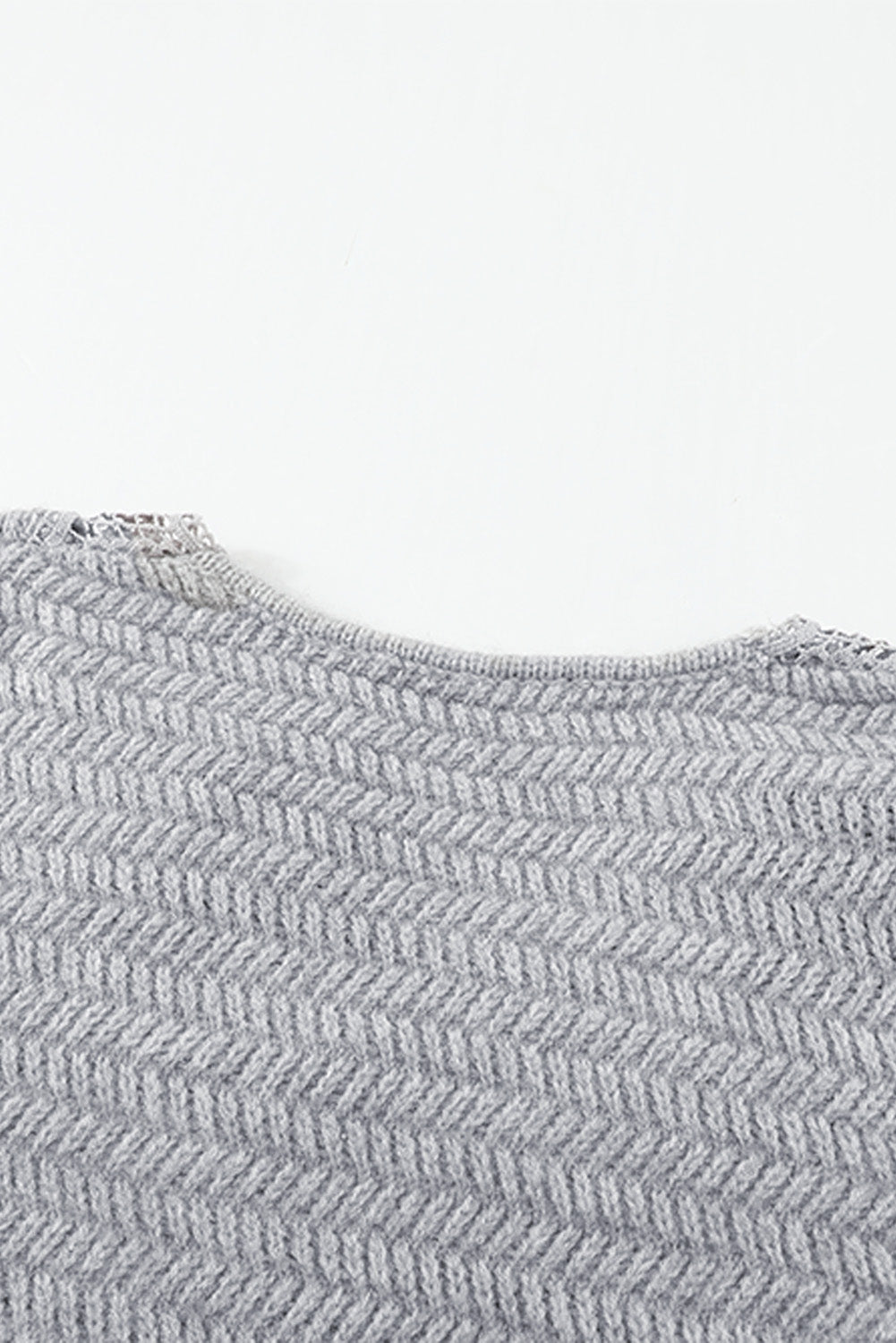 Gray loose sweater featuring a lace scalloped V-neck and side split design, perfect for a chic and comfortable look.