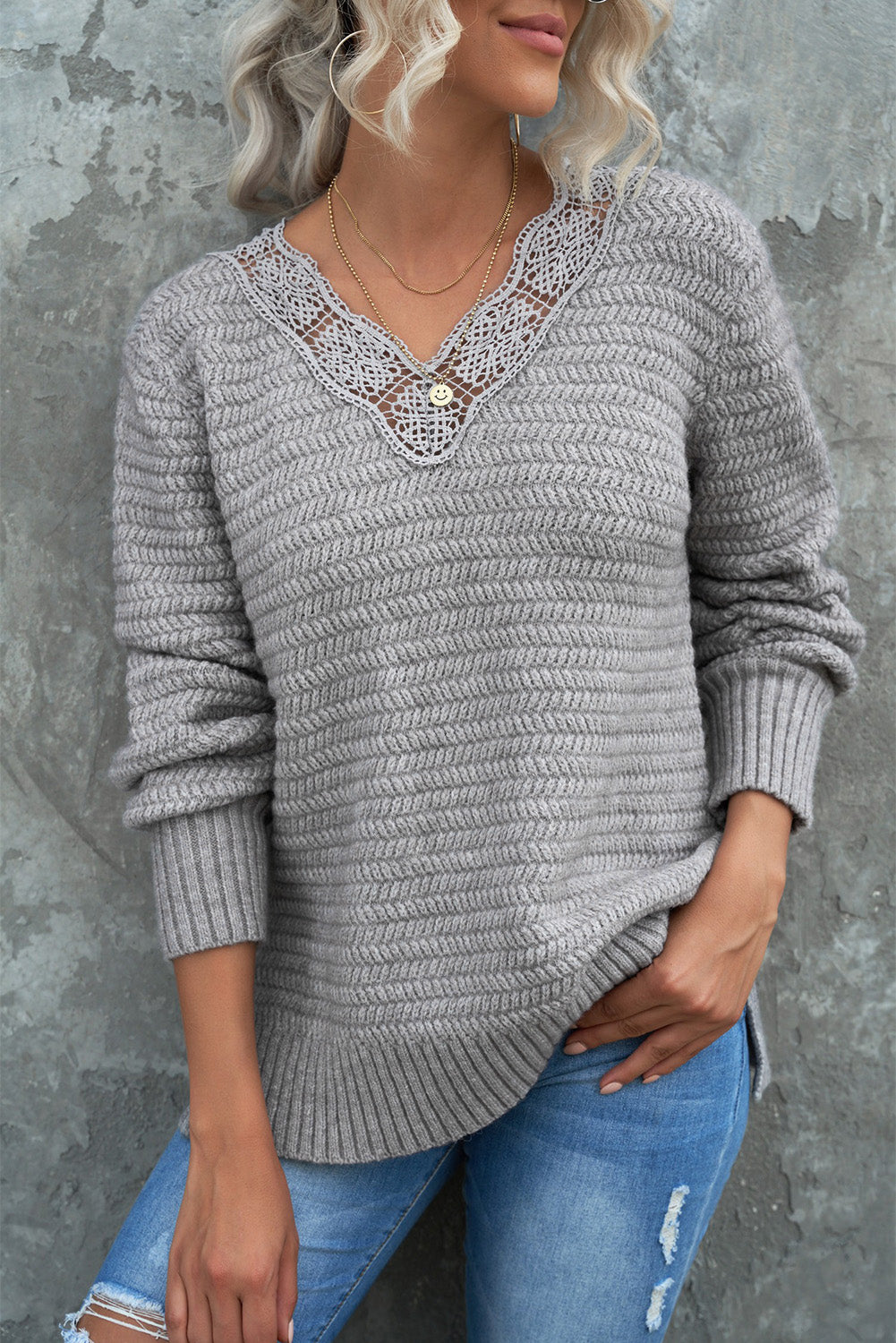 Gray loose sweater featuring a lace scalloped V-neck and side split design, perfect for a chic and comfortable look.