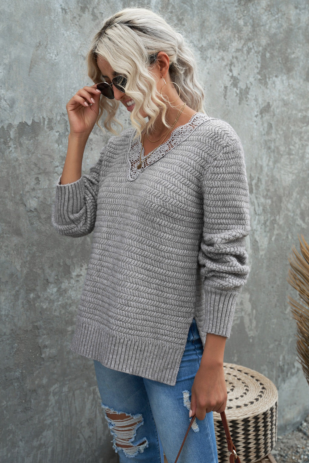 Gray loose sweater featuring a lace scalloped V-neck and side split design, perfect for a chic and comfortable look.