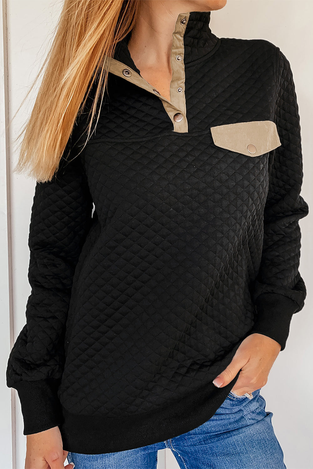 Gray quilted pullover sweatshirt with snaps and a stand neck, featuring a stylish fake front pocket.