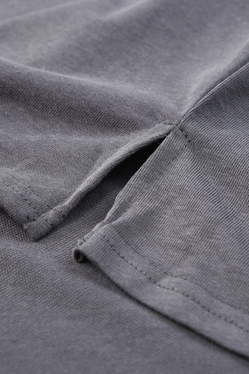 Gray Split V Neck Dolman Top featuring a relaxed fit, long sleeves with elastic cuffs, and a stylish high-low hemline.