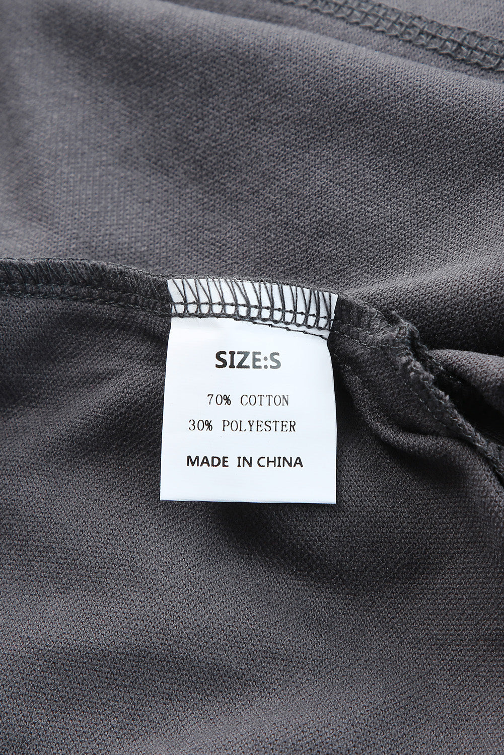 Gray Split V Neck Dolman Top featuring a relaxed fit, long sleeves with elastic cuffs, and a stylish high-low hemline.