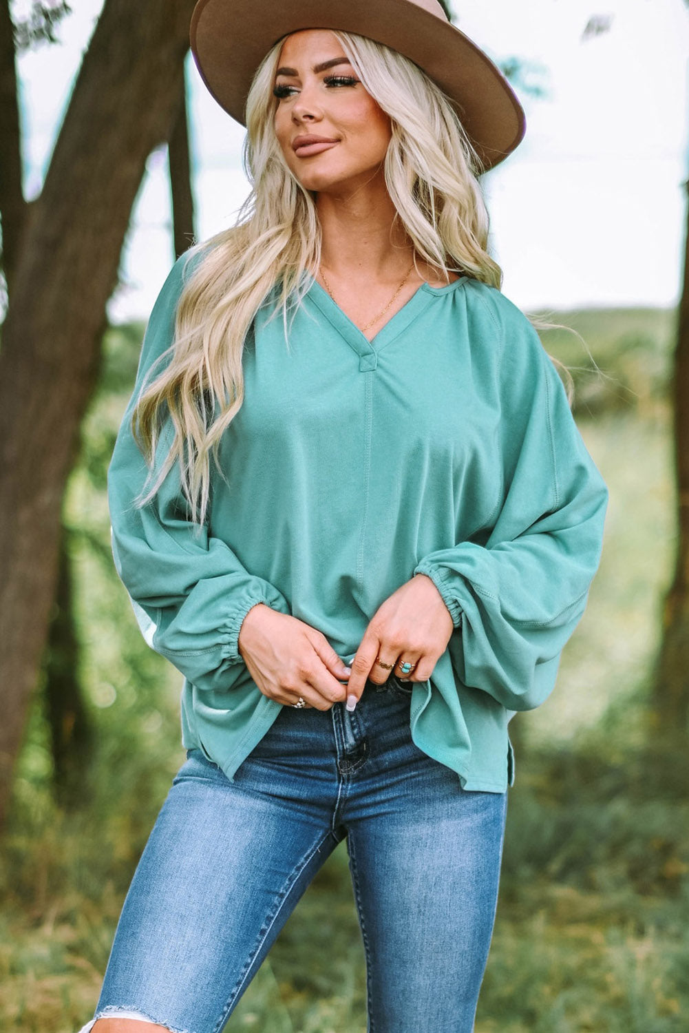 Gray Split V Neck Dolman Top featuring a relaxed fit, long sleeves with elastic cuffs, and a stylish high-low hemline.