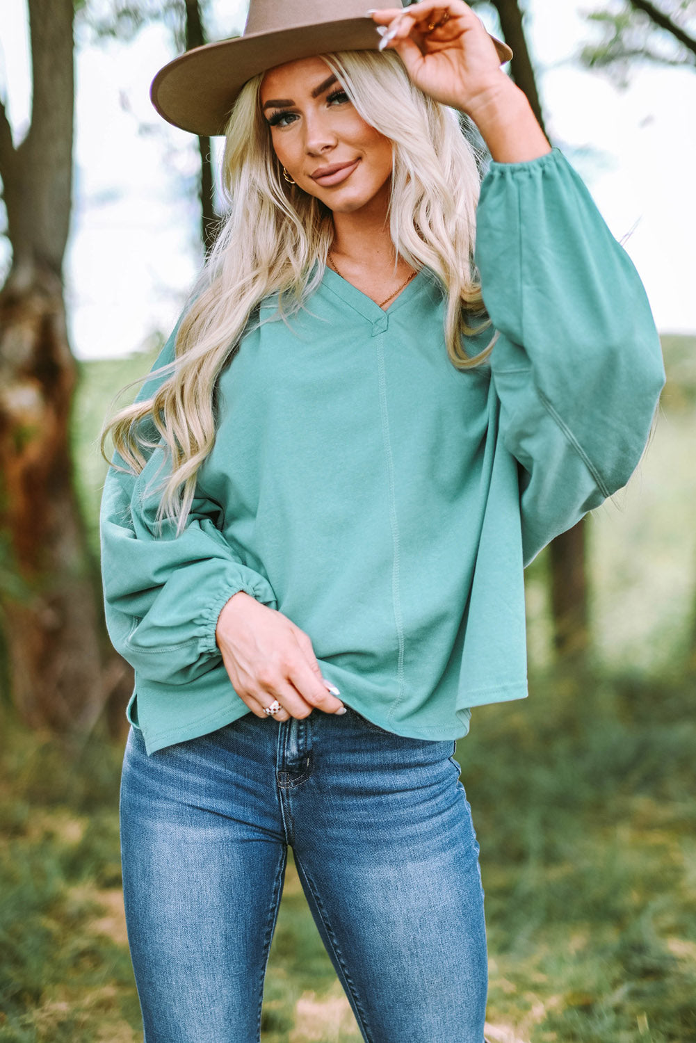 Gray Split V Neck Dolman Top featuring a relaxed fit, long sleeves with elastic cuffs, and a stylish high-low hemline.