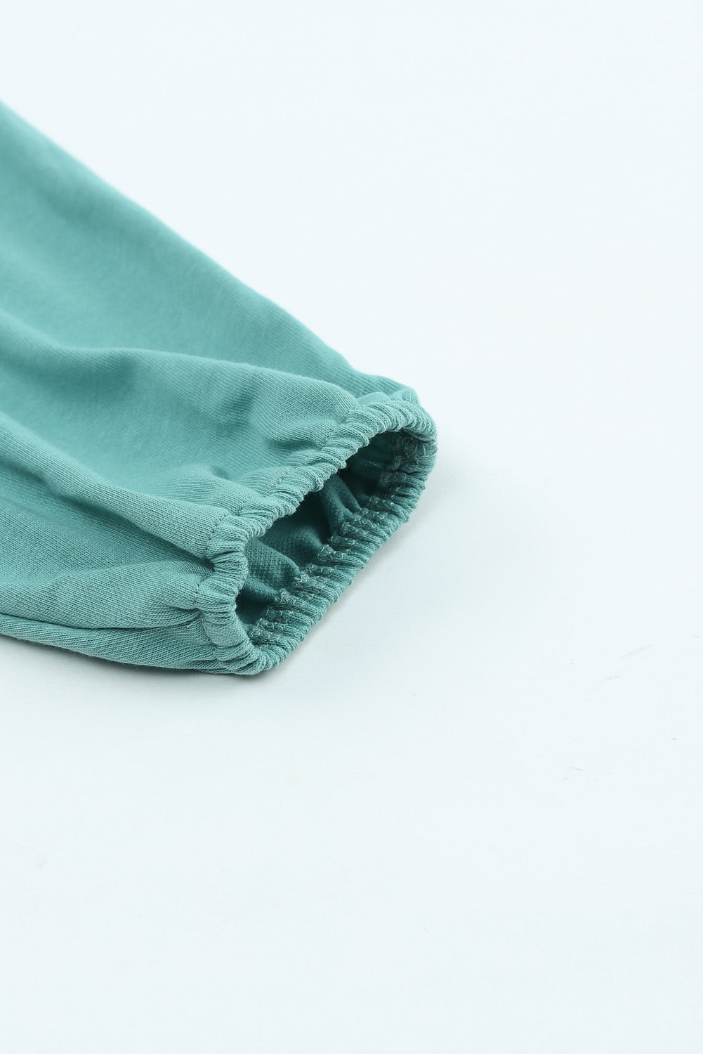 Gray Split V Neck Dolman Top featuring a relaxed fit, long sleeves with elastic cuffs, and a stylish high-low hemline.