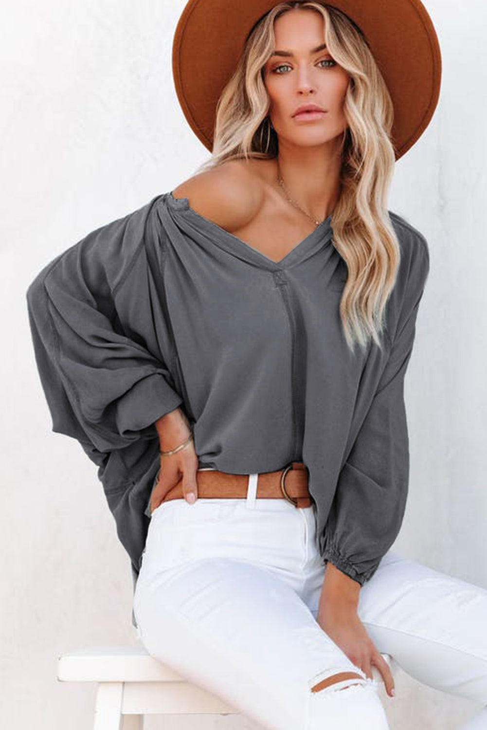 Gray Split V Neck Dolman Top featuring a relaxed fit, long sleeves with elastic cuffs, and a stylish high-low hemline.