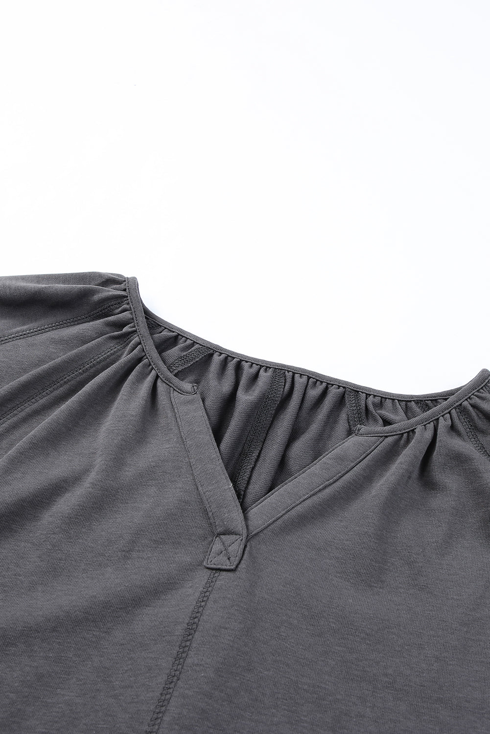 Gray Split V Neck Dolman Top featuring a relaxed fit, long sleeves with elastic cuffs, and a stylish high-low hemline.