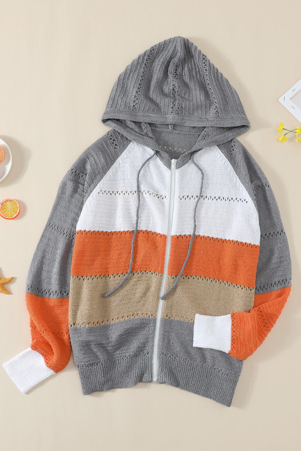 Gray zipped front colorblock hollow-out knit hoodie with drawstring hood and stylish design.