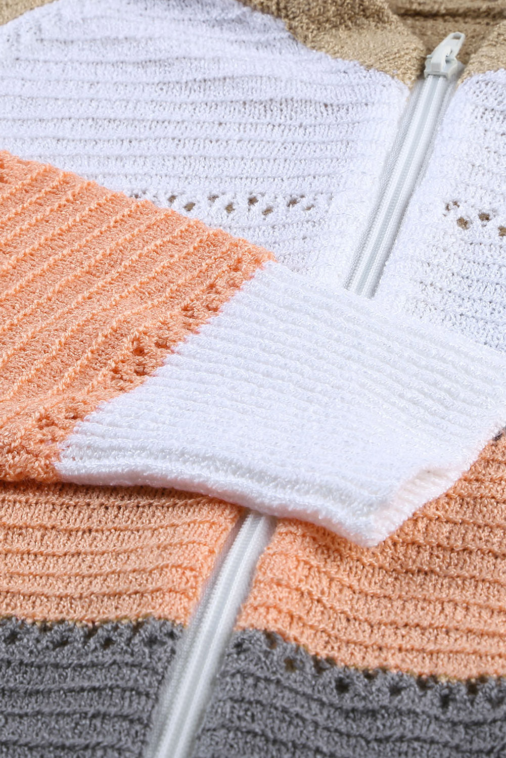 Gray zipped front colorblock hollow-out knit hoodie with drawstring hood and stylish design.