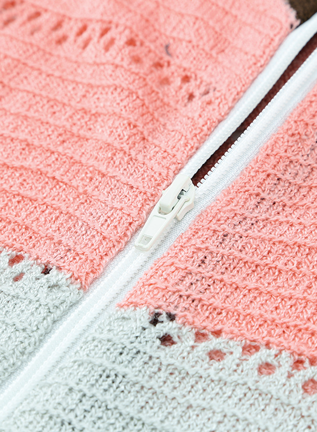 Gray zipped front colorblock hollow-out knit hoodie with drawstring hood and stylish design.