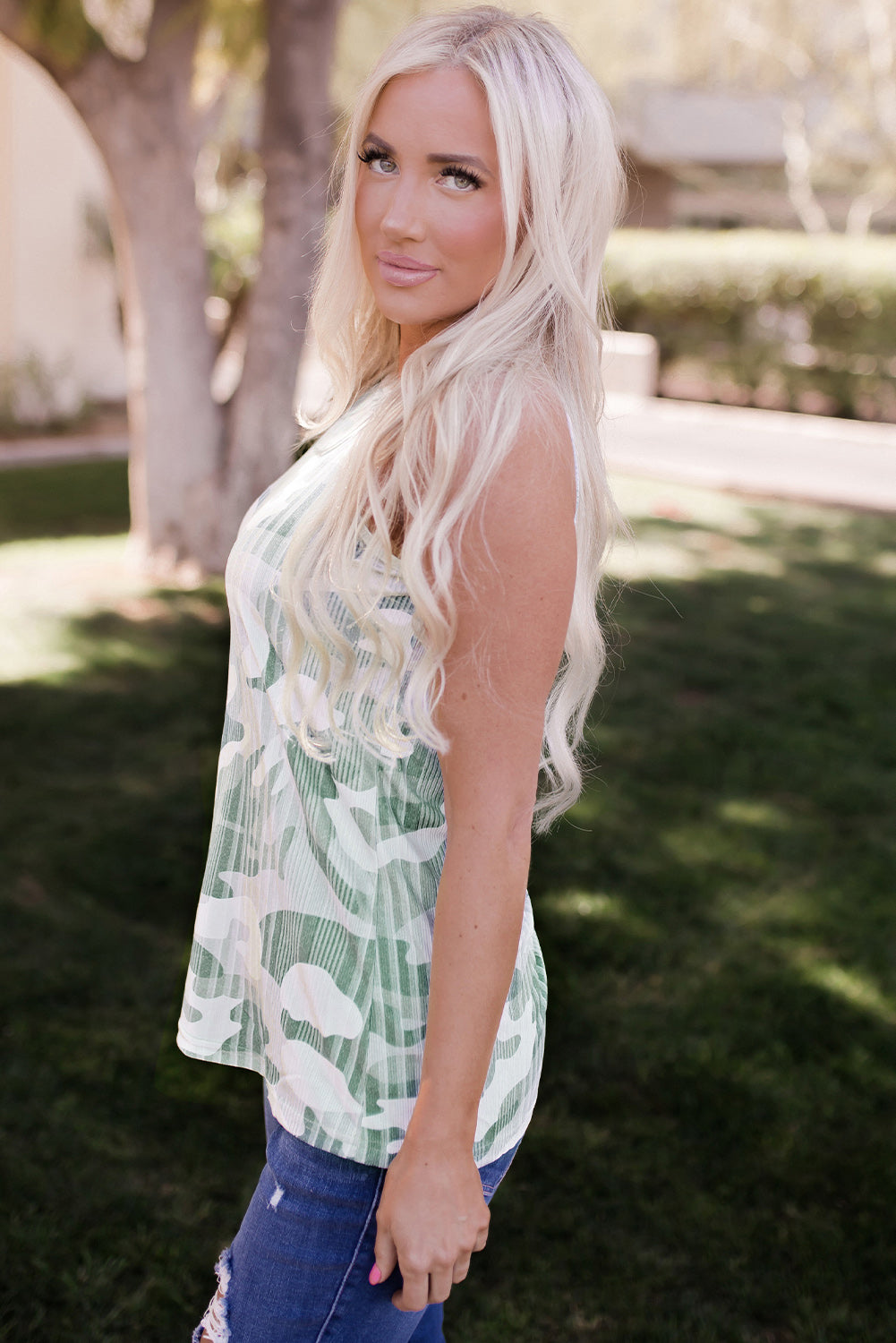 A stylish green camo tank top featuring a halter neck design, made from lightweight and breathable fabric, perfect for casual wear.