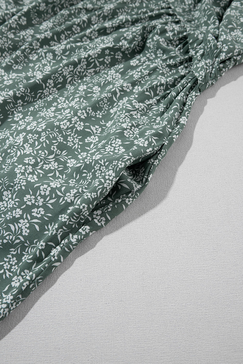 A stylish green floral print collared babydoll dress with puff sleeves, perfect for casual and dressy occasions.