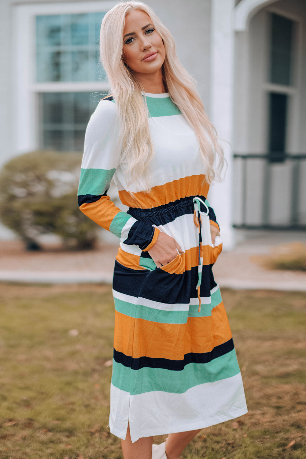 A stylish green multicolor block midi dress with a drawstring waist and long sleeves, perfect for fall fashion.
