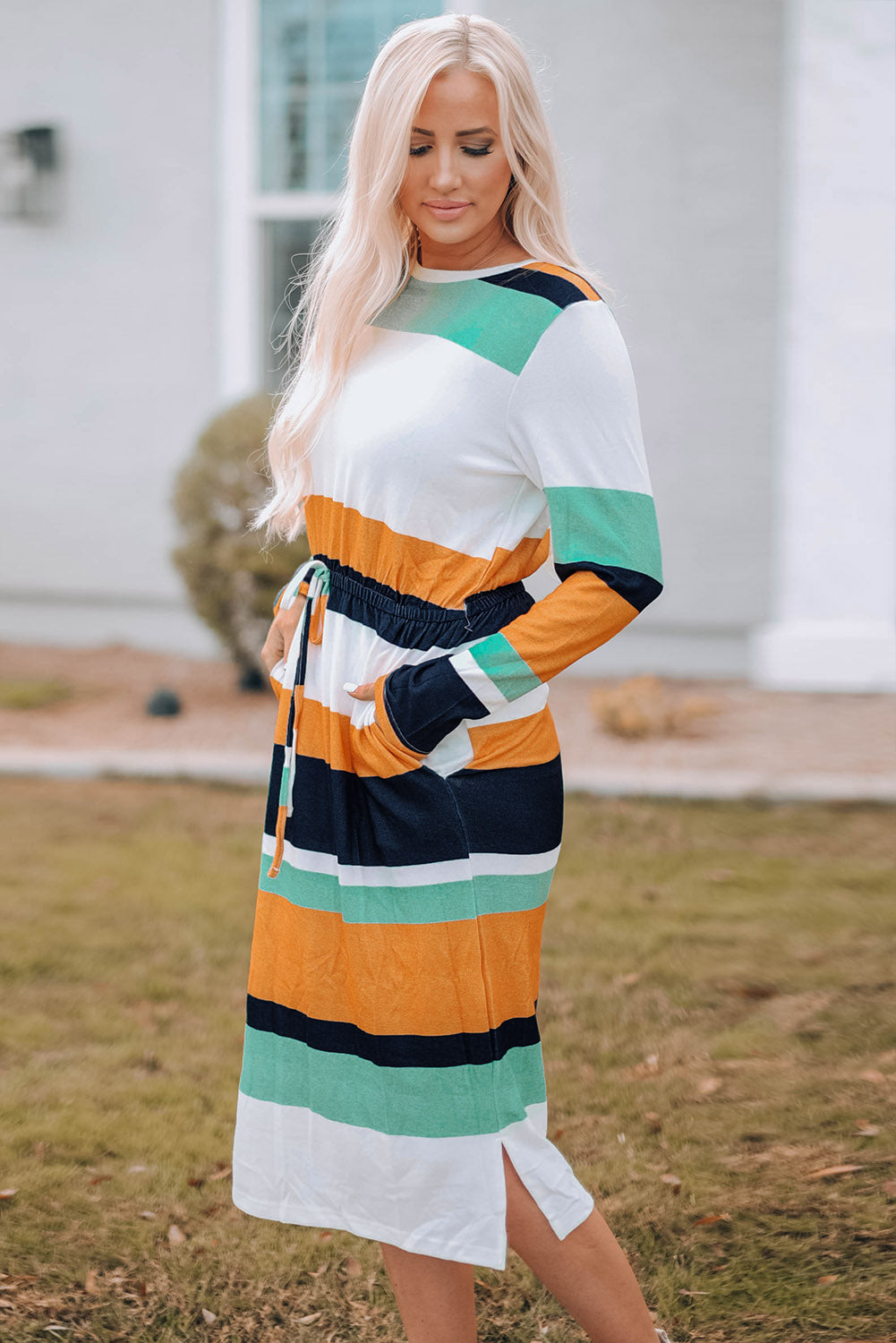 A stylish green multicolor block midi dress with a drawstring waist and long sleeves, perfect for fall fashion.