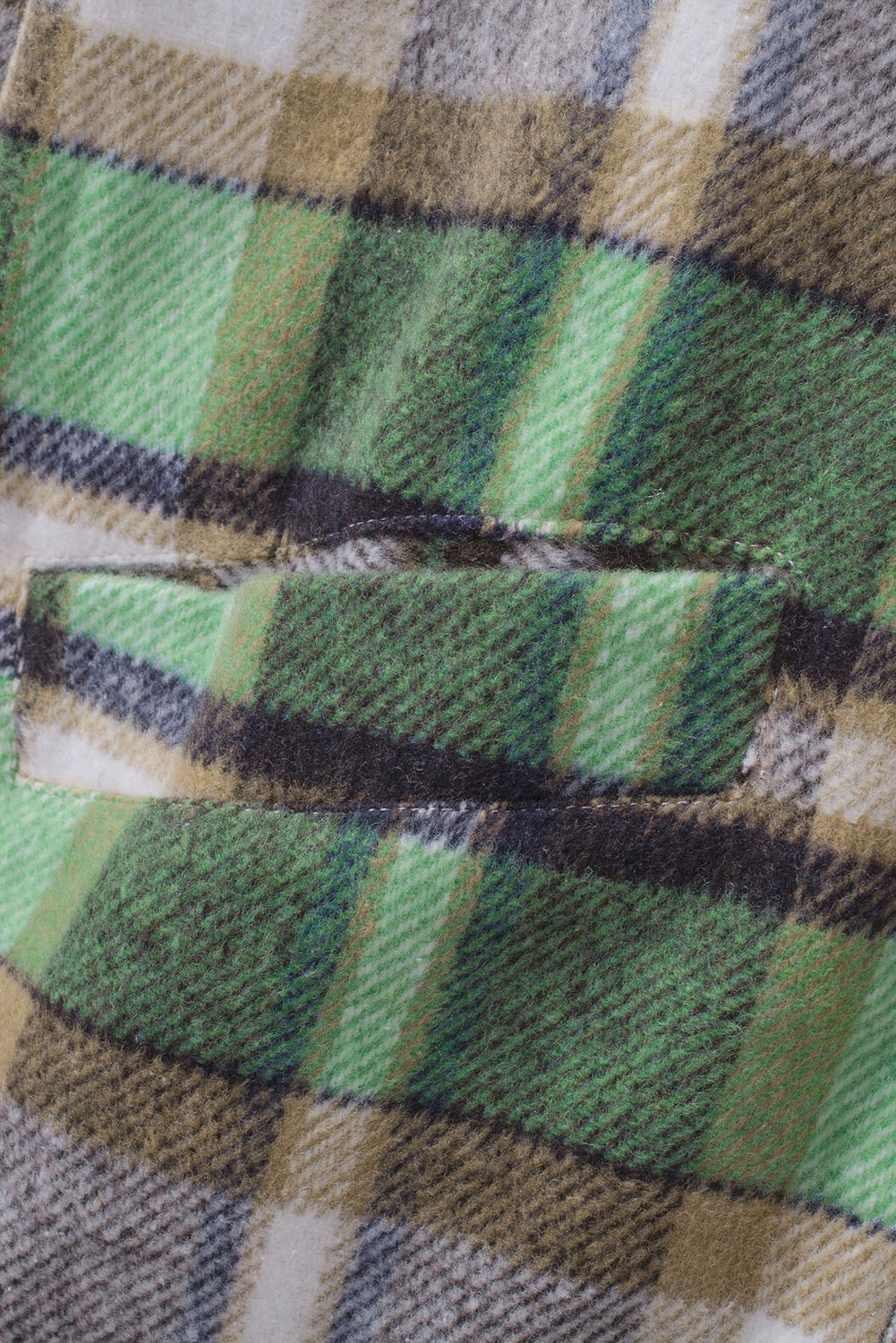 Green plaid shacket with pockets, featuring a turn-down collar and button closure, perfect for stylish layering.