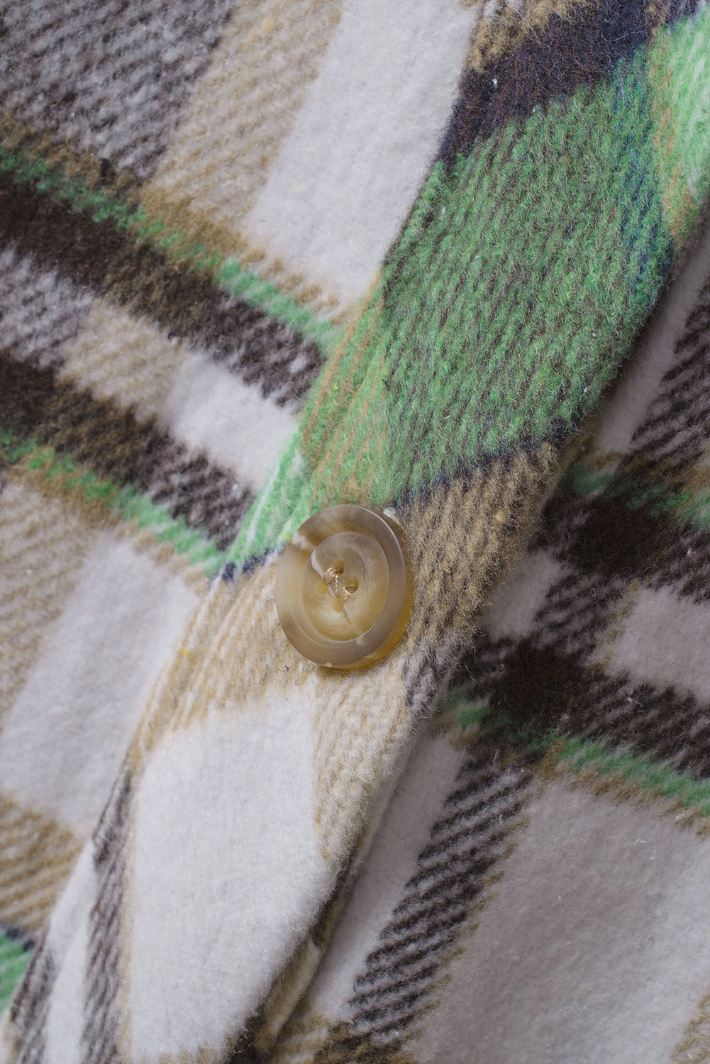 Green plaid shacket with pockets, featuring a turn-down collar and button closure, perfect for stylish layering.