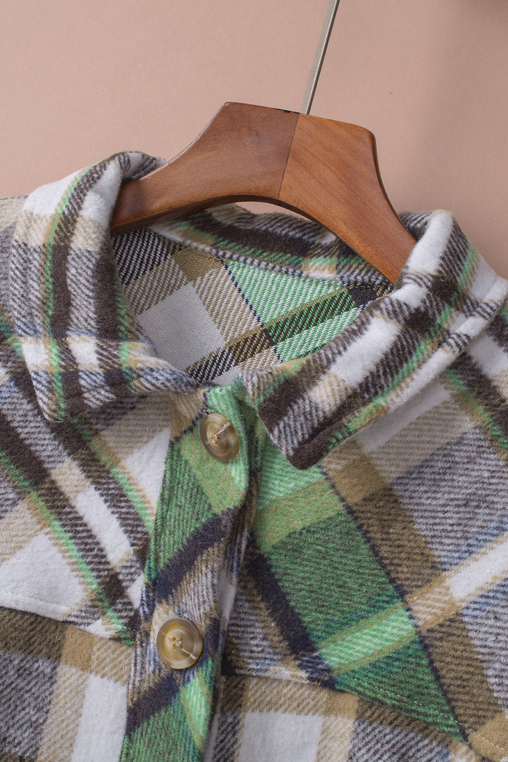 Green plaid shacket with pockets, featuring a turn-down collar and button closure, perfect for stylish layering.