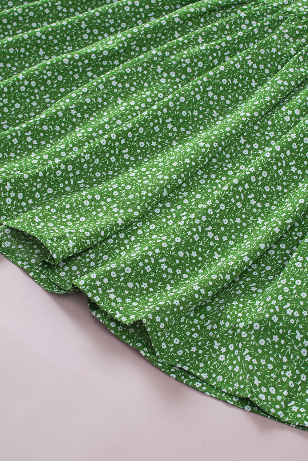 A stylish green plus size floral peplum top featuring a v-neck, flutter sleeves, and a flowy waist design, perfect for casual outings.