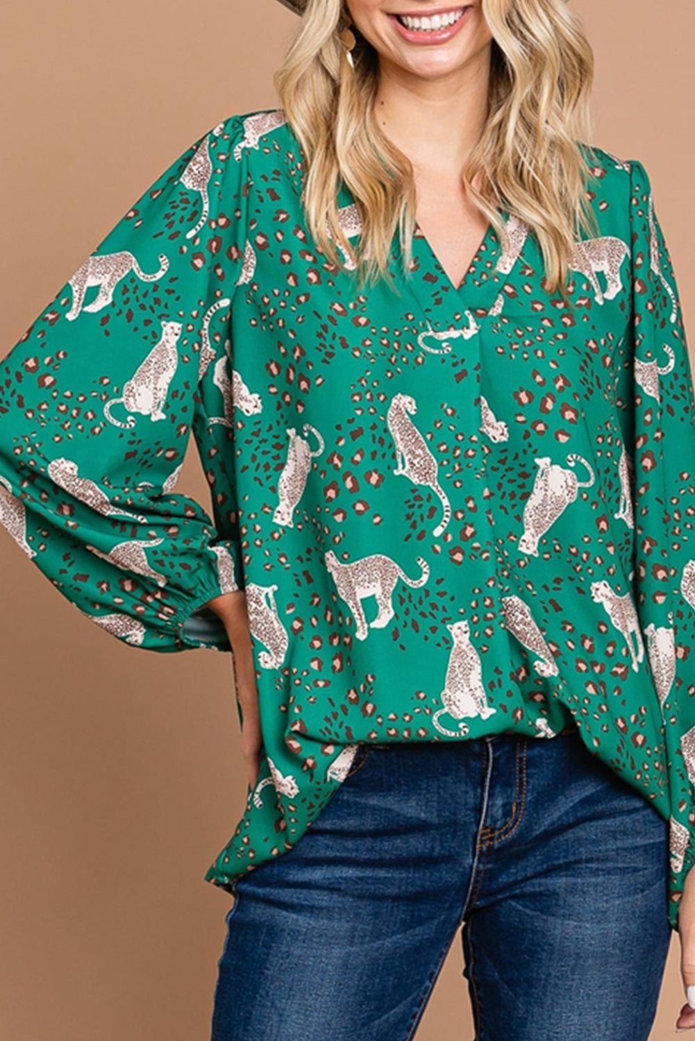 A stylish green blouse featuring a cheetah print design, V-neck, and flowy silhouette, perfect for casual wear.