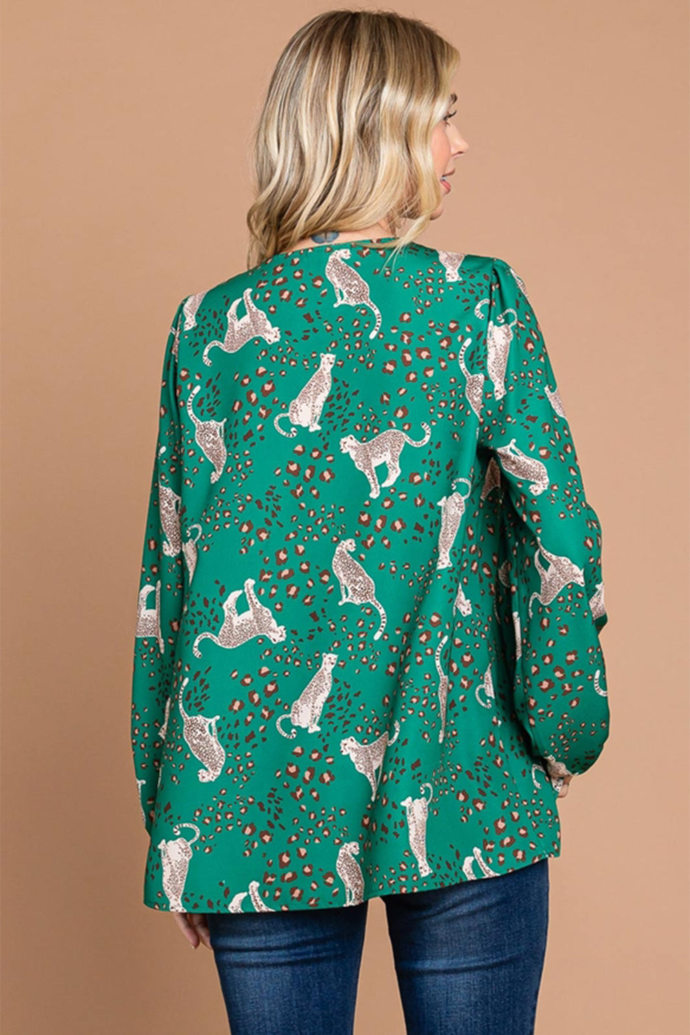 A stylish green blouse featuring a cheetah print design, V-neck, and flowy silhouette, perfect for casual wear.