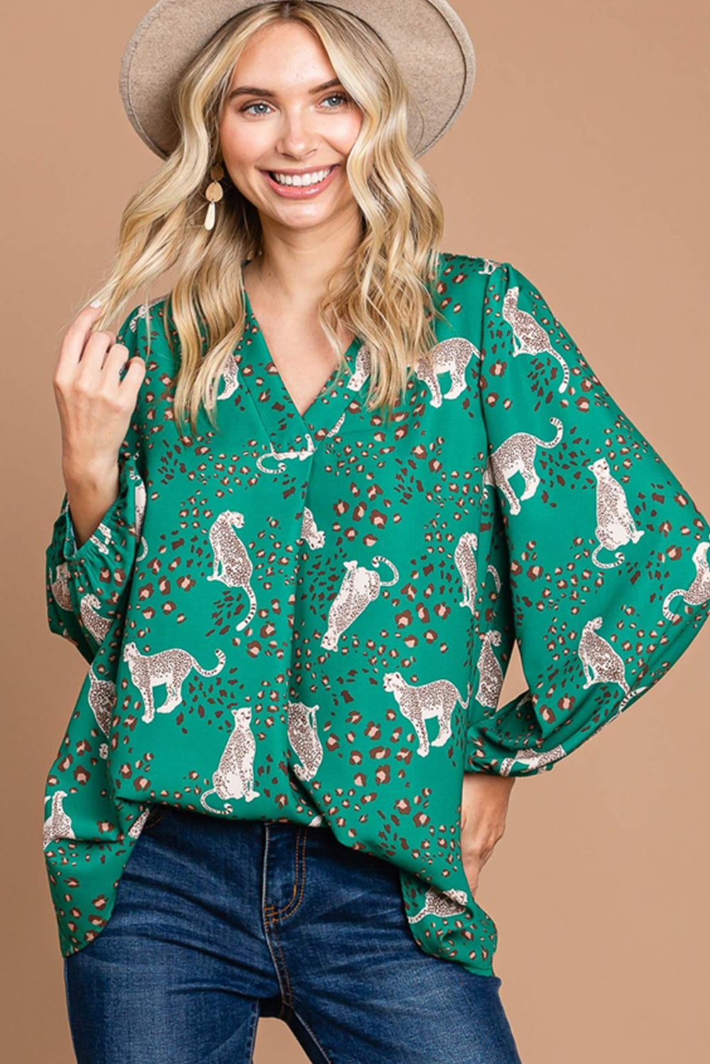 A stylish green blouse featuring a cheetah print design, V-neck, and flowy silhouette, perfect for casual wear.