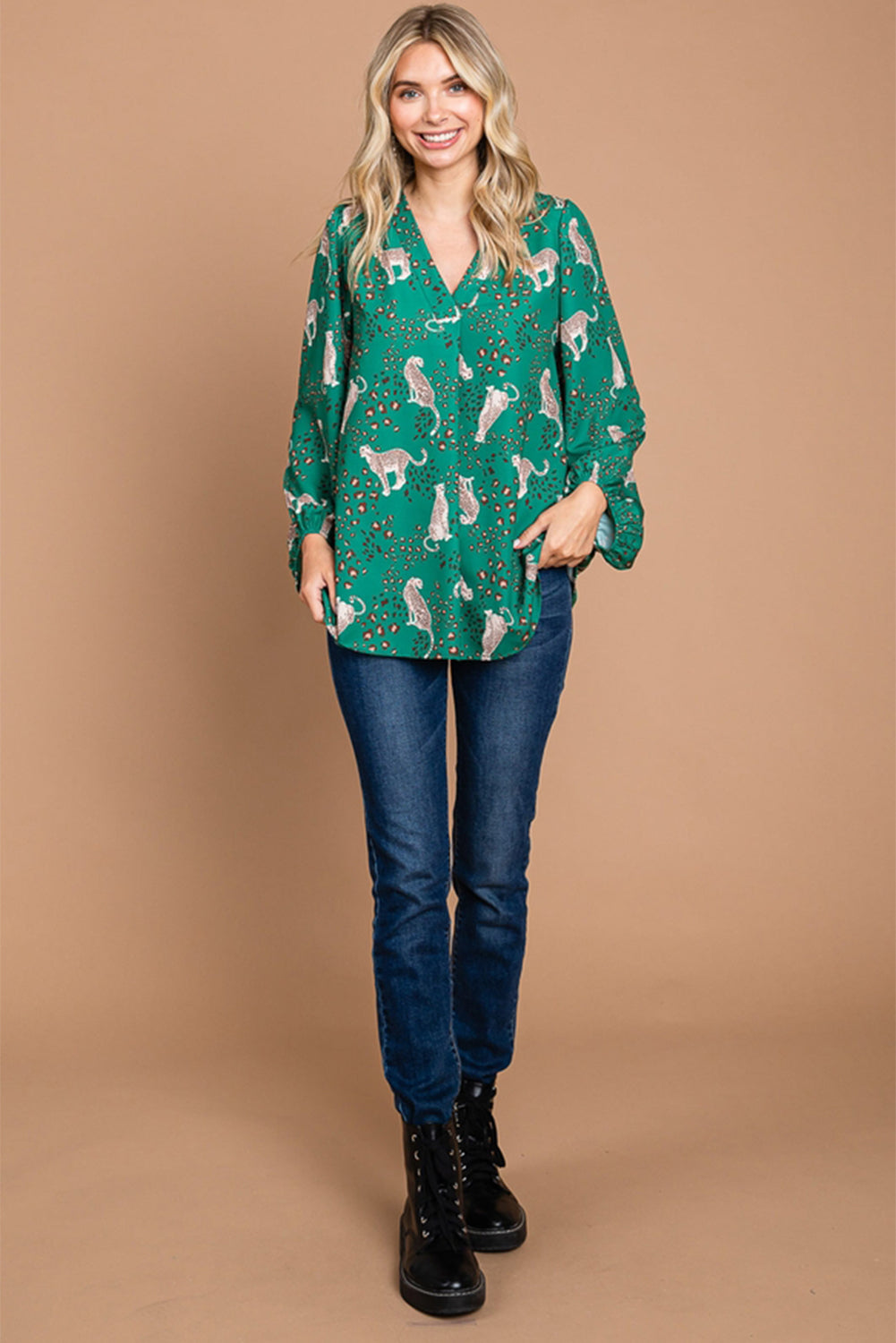 A stylish green blouse featuring a cheetah print design, V-neck, and flowy silhouette, perfect for casual wear.