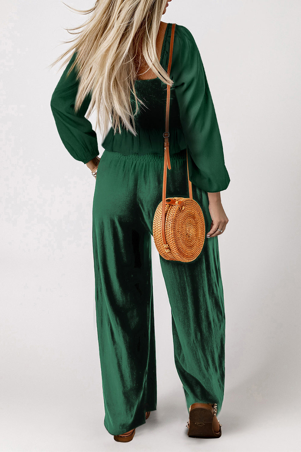 A stylish green square neck smocked peplum top paired with loose-fitting pants, showcasing a ruffled hemline and side pockets, perfect for modern ladies.