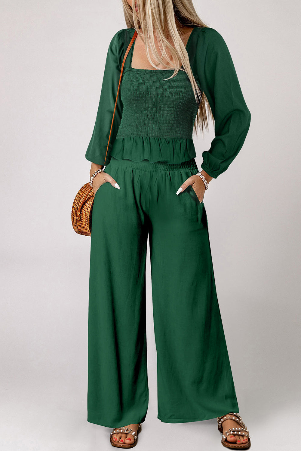 A stylish green square neck smocked peplum top paired with loose-fitting pants, showcasing a ruffled hemline and side pockets, perfect for modern ladies.