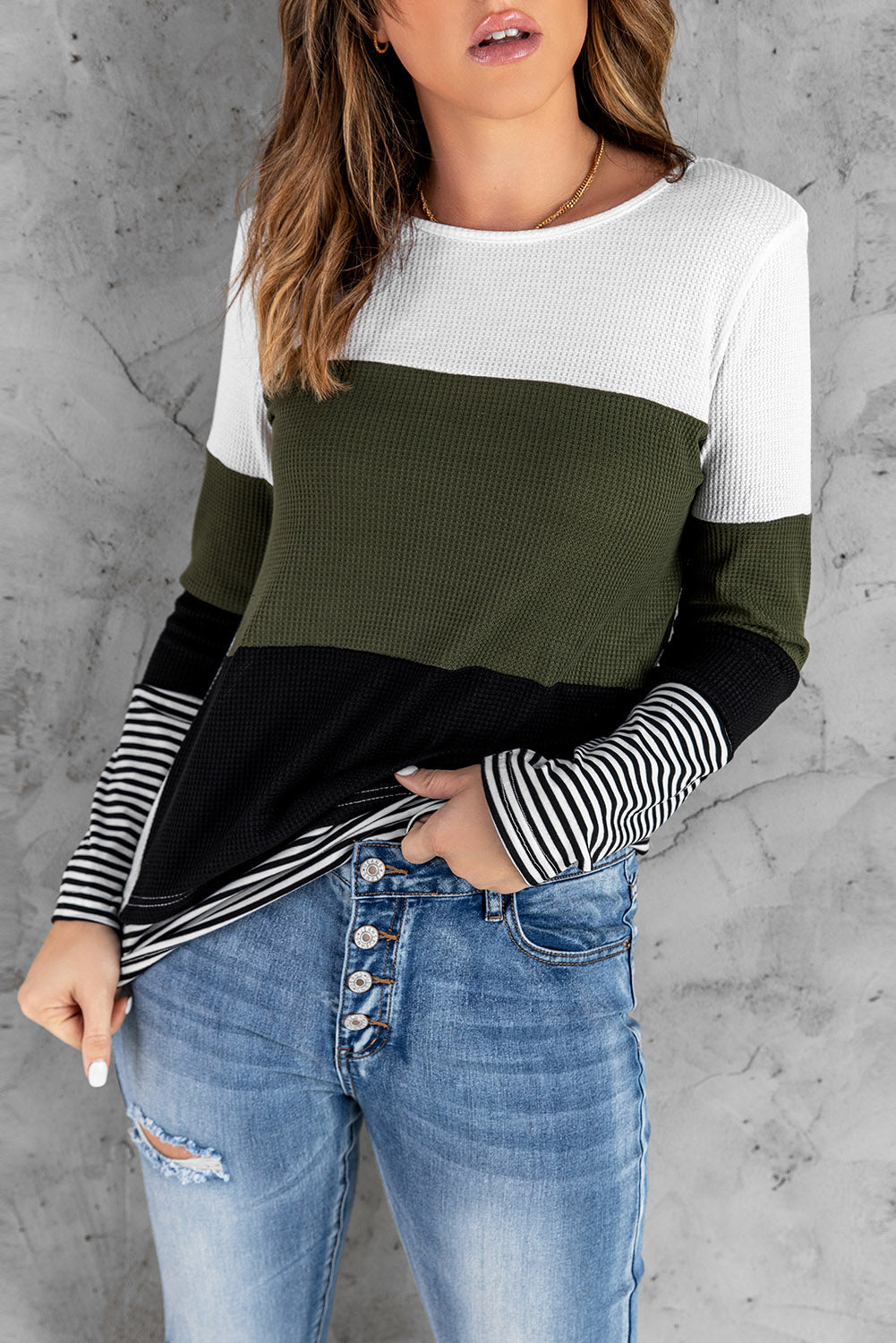 A stylish green top featuring colorblock and striped splicing design, perfect for casual wear.