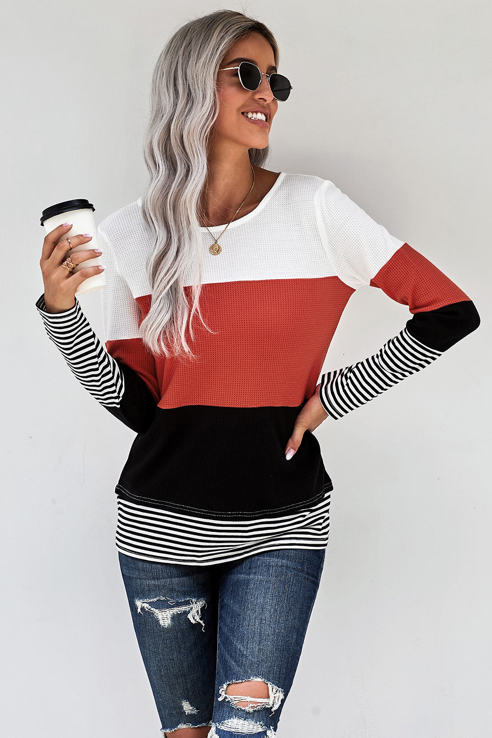 A stylish green top featuring colorblock and striped splicing design, perfect for casual wear.