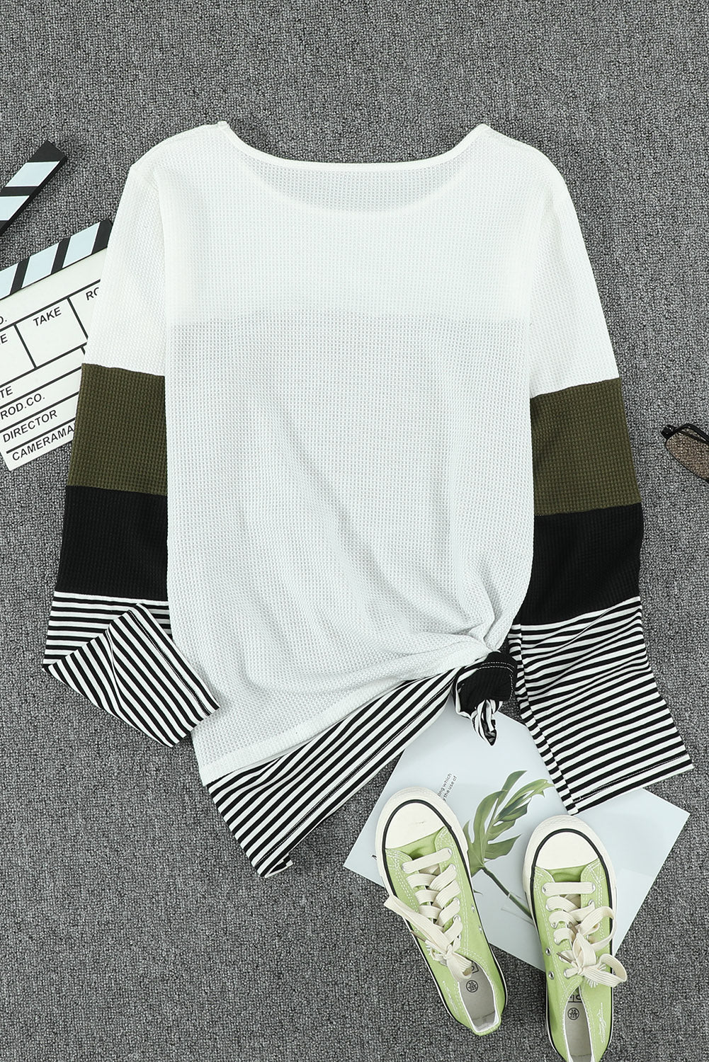 A stylish green top featuring colorblock and striped splicing design, perfect for casual wear.
