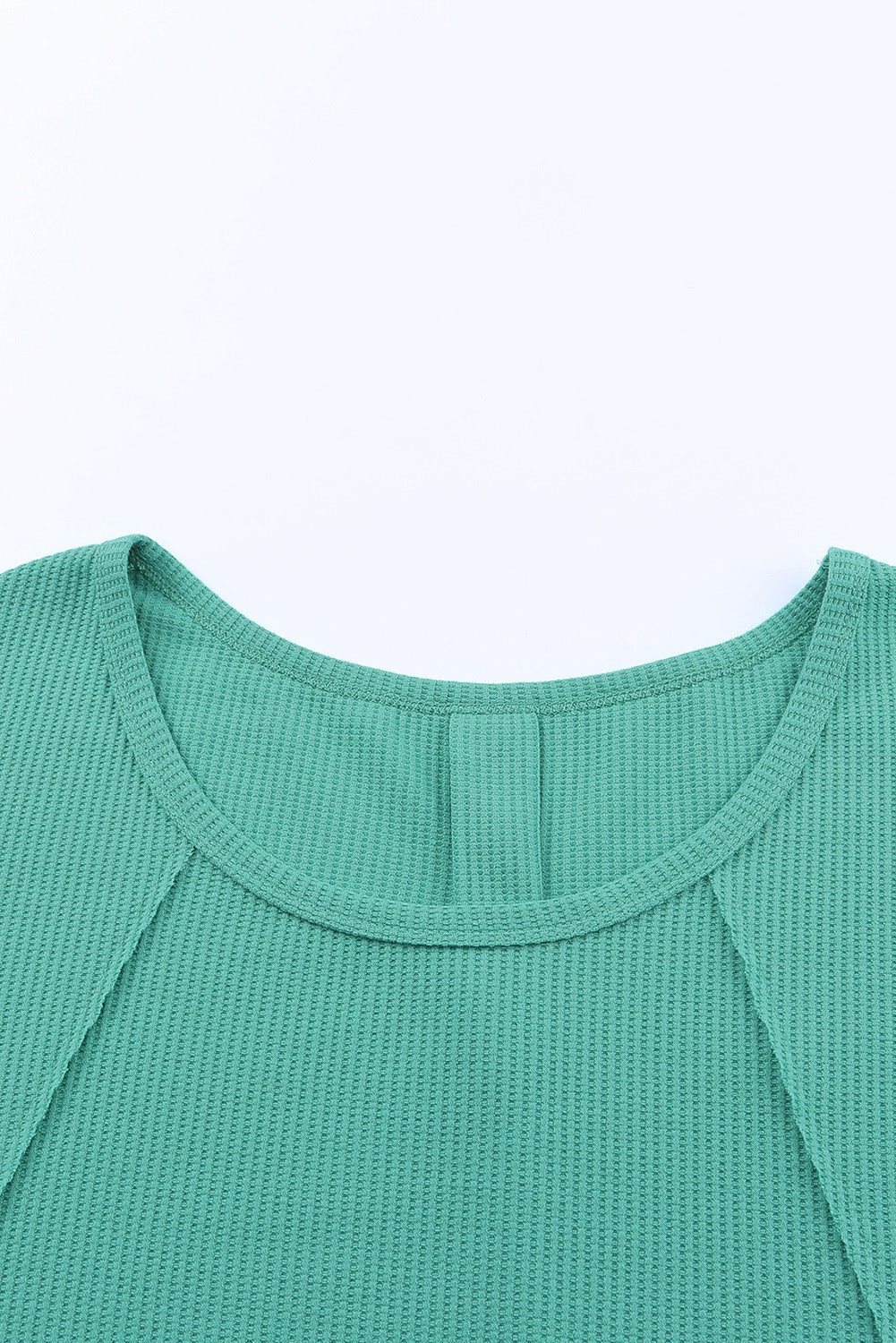 A stylish green waffle knit long sleeve top featuring splicing buttons and a crew neckline, perfect for casual wear.