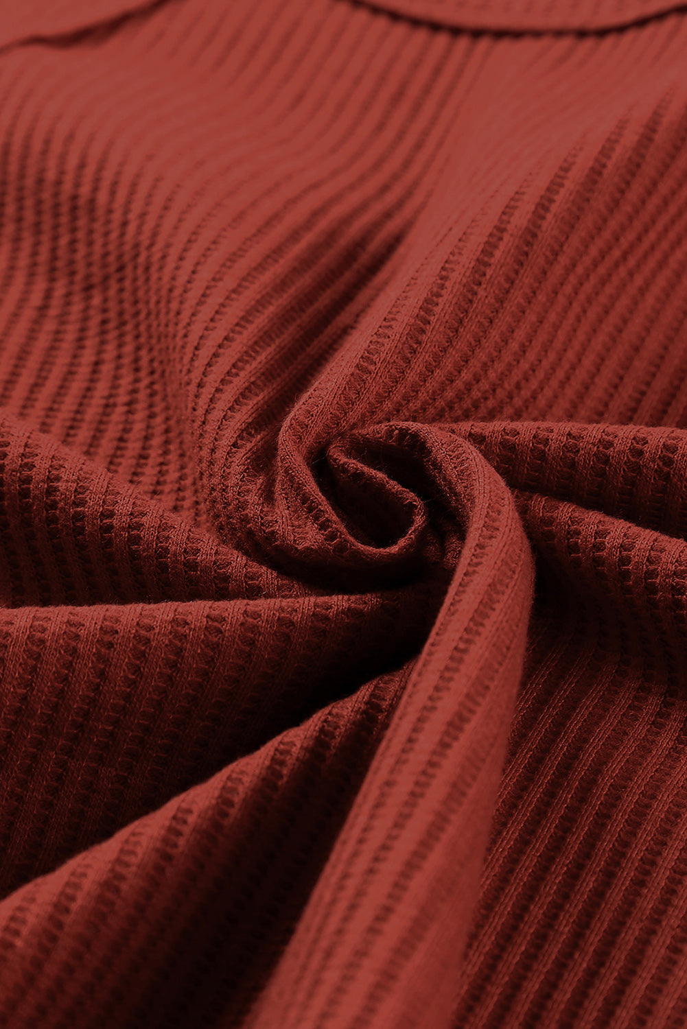 A stylish green waffle knit long sleeve top featuring splicing buttons and a crew neckline, perfect for casual wear.