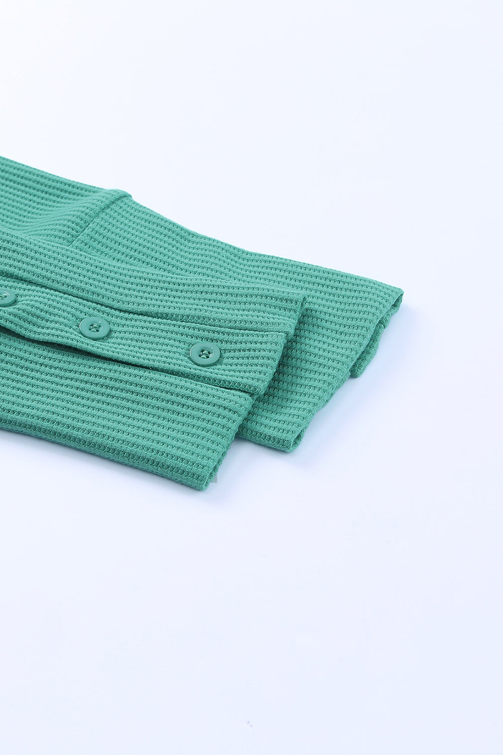 A stylish green waffle knit long sleeve top featuring splicing buttons and a crew neckline, perfect for casual wear.