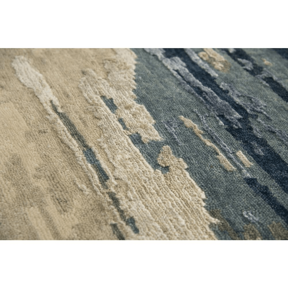 Hand Knotted Cut Pile Wool/Viscose Rug in blues and greys on a beige background, measuring 9' x 12', showcasing intricate artisan craftsmanship.