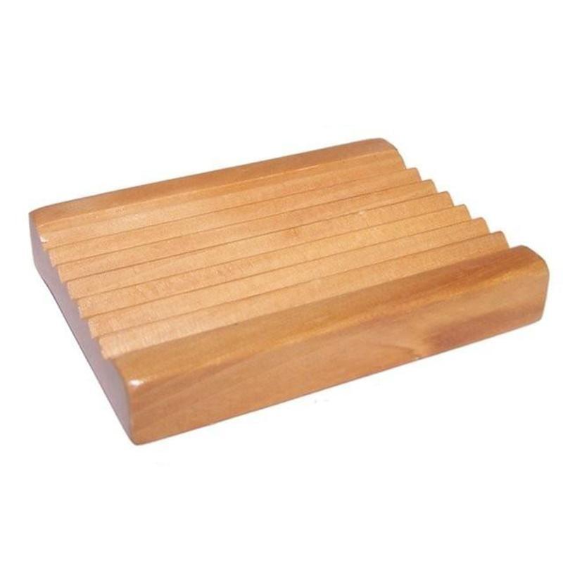 A beautifully crafted Hemu wood soap dish with grooves for drainage, showcasing its natural wood grain.