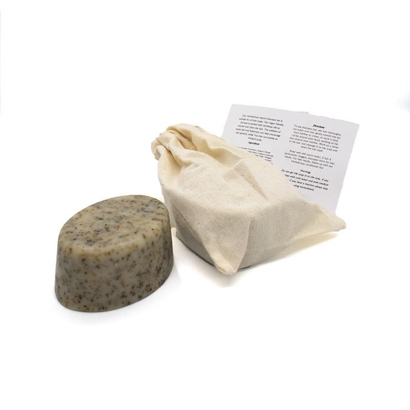 Herbalicious Organic Shampoo Bar featuring nettles and rosemary, packaged in eco-friendly cotton bag, ideal for all hair types.