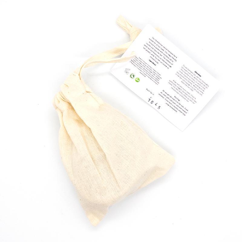 Herbalicious Organic Shampoo Bar featuring nettles and rosemary, packaged in eco-friendly cotton bag, ideal for all hair types.